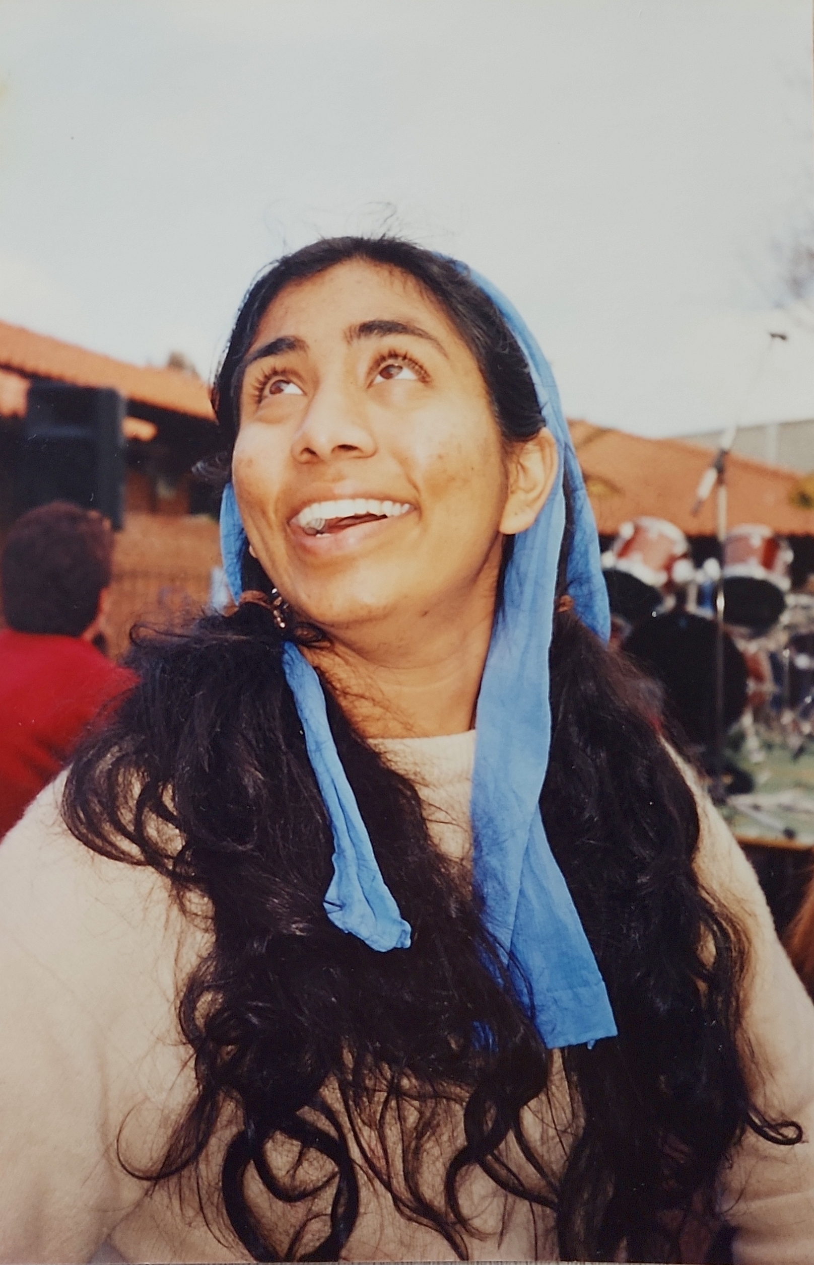 Photo shows Zaneta Mascarenhas as an engineering student on the Curtin Bentley campus in the early 2000s. Zaneta is in an outdoor courtyard smiling and looking upwards.
